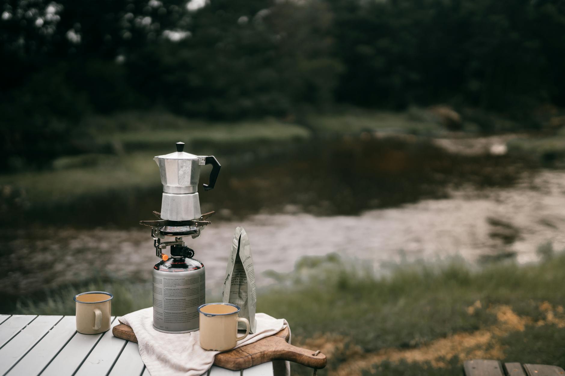 a moka pot near mugs